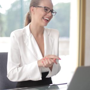 Canva - Smiling businesswoman with laptop in office CROPPED