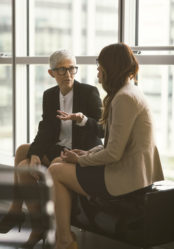 Businesswomen working in the office. Sitting and talking.